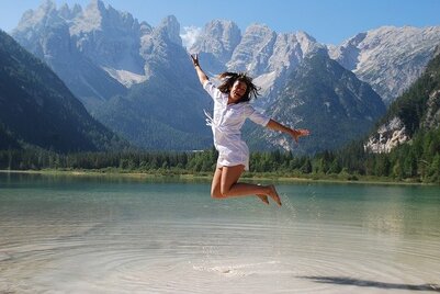 Picture of young woman jumping for joy